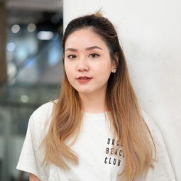 Hair colors for fair skin: Asian woman with long bacl to brown ombre hair wearing a shirt