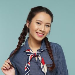 Messy two braids hairstyle: Closeup shot of an Asian woman with long dark hair in messy two braids hairstyle