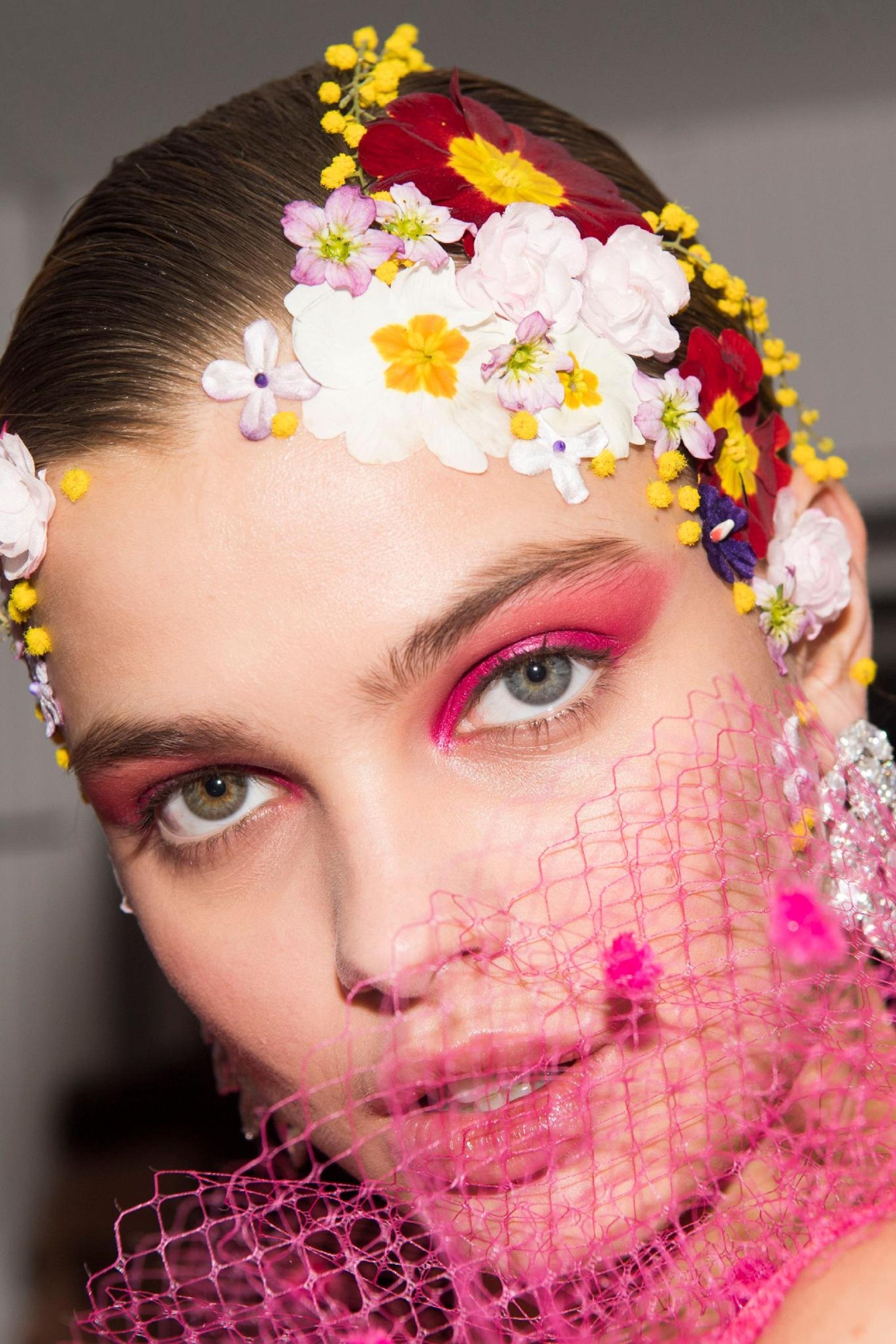 Paris Fashion Week 2019: Closeup shot of a woman with flower accessories on her hair