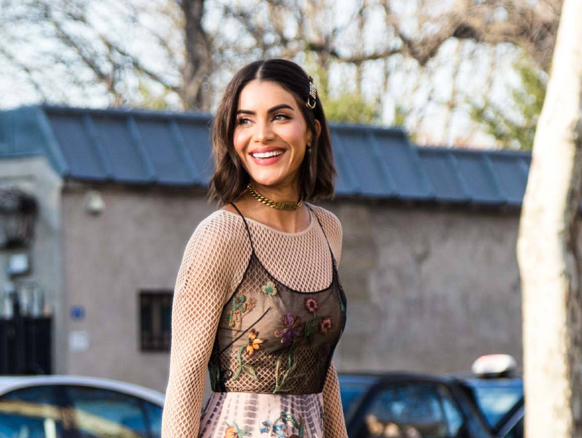 Paris Fashion Week 2019: Woman wearing a thin-strapped top and skirt outdoors with dark brown lob with hair clip
