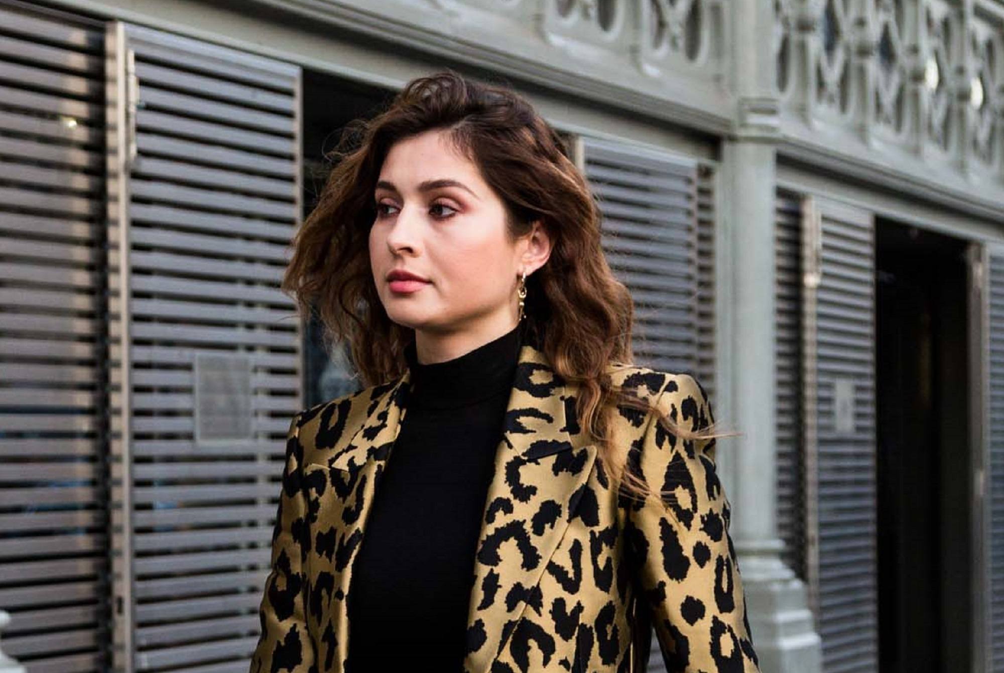 Paris Fashion Week 2019: Woman wearing a leopard print jacket with dark brown wavy lob outdoors