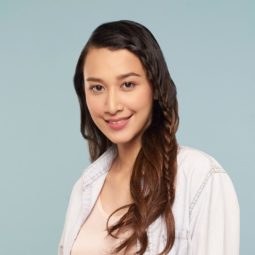 Simple braids: Asian woman wearing a white polo with long dark hair in face framing lace braid