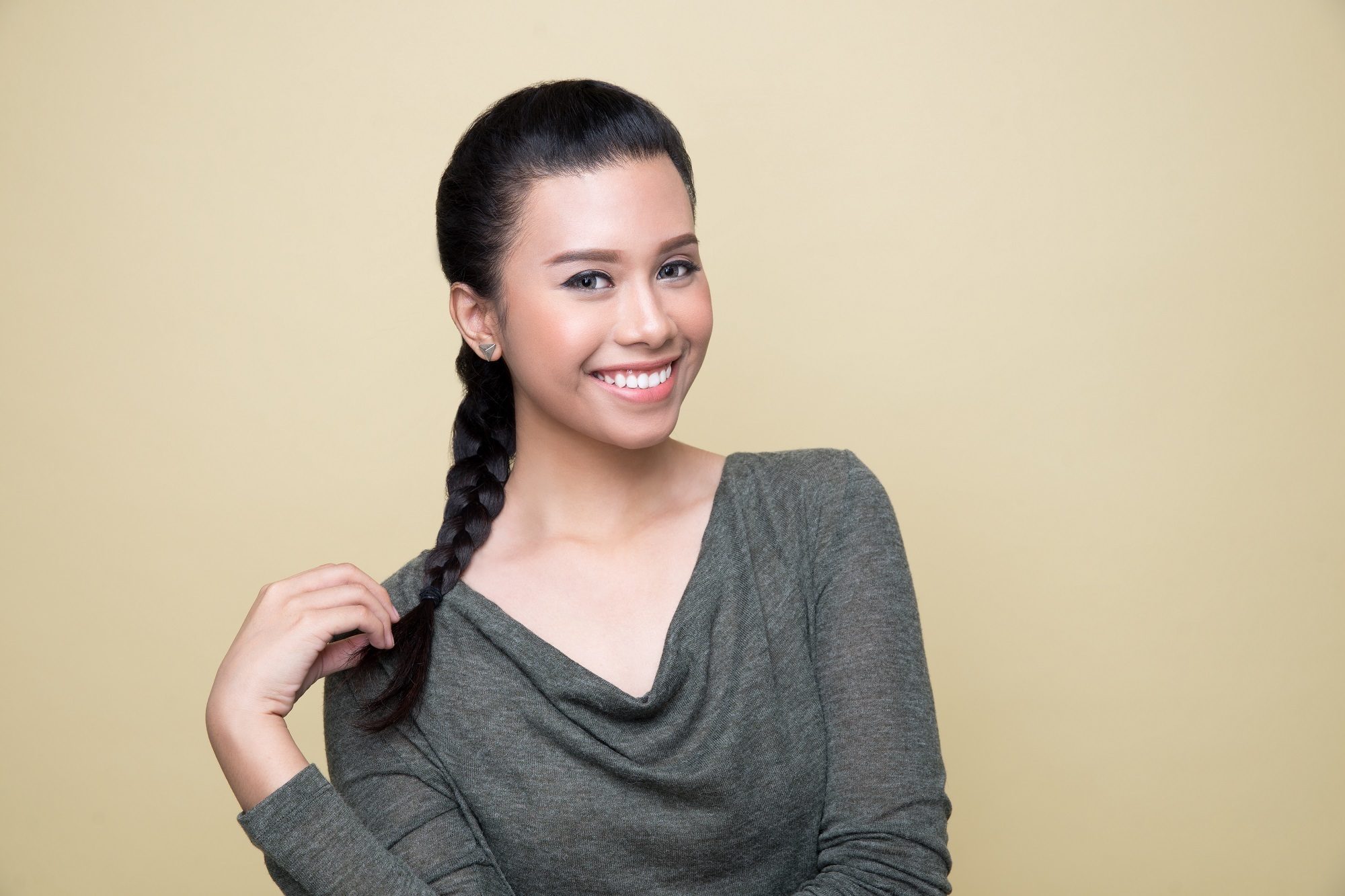Simple braids: Asian woman wearing a dark gray long-sleeved shirt with long black hair in a French braid
