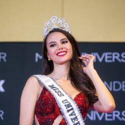 Catriona Gray closeup shot of a woman with long dark wavy hair wearing a red dress