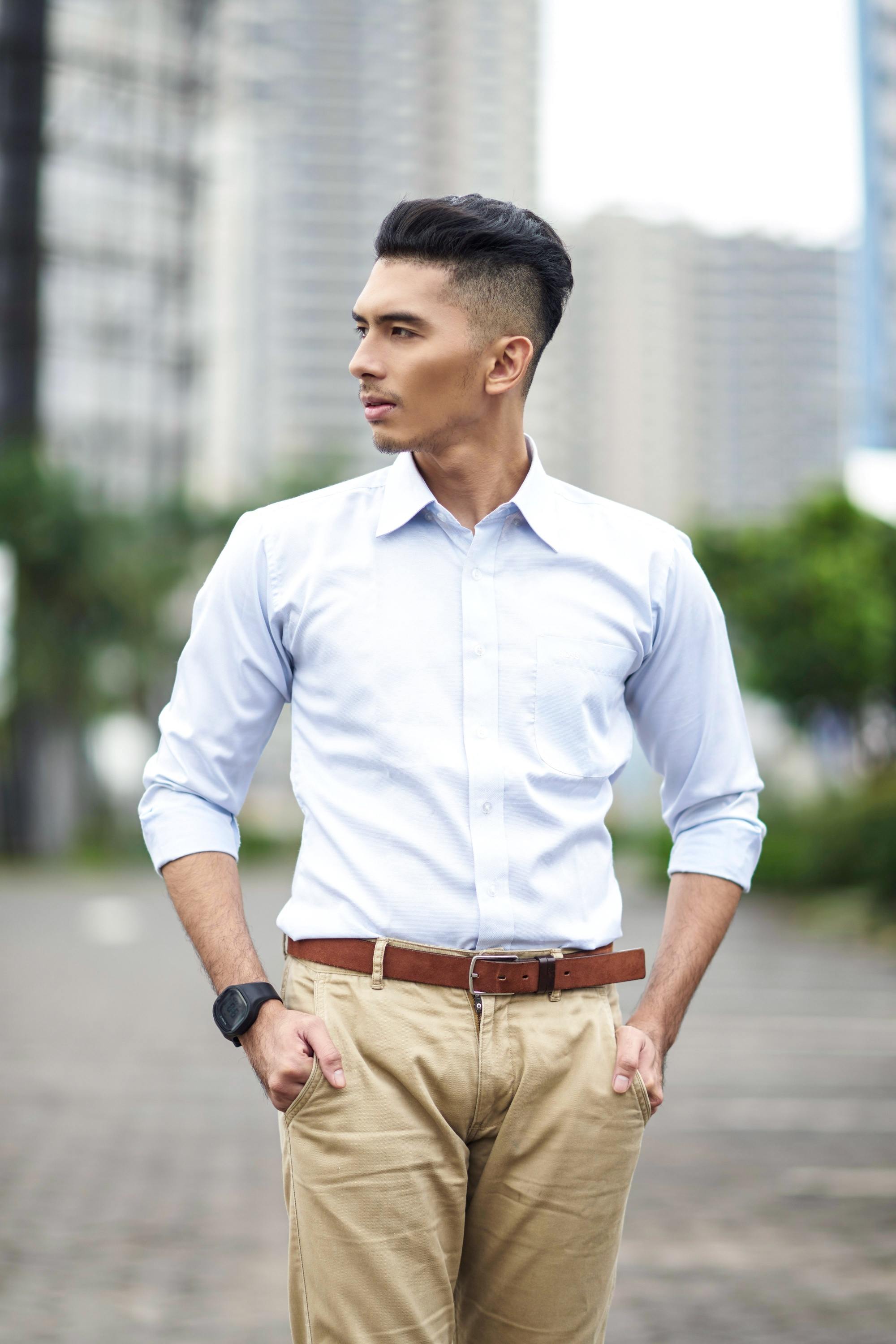Asian man wearing a dress shirt and pants outdoors