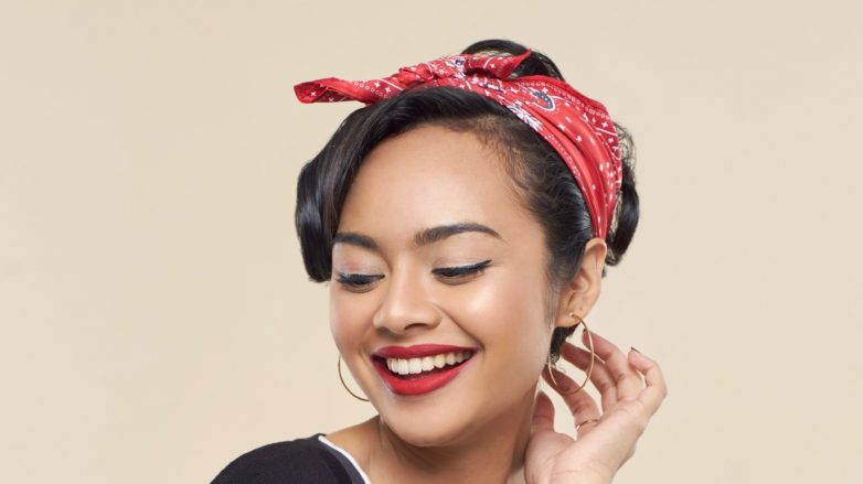 Pin hair: Closeup shot of an Asian woman with long black hair in pin up hair wearing a red scarf on her head