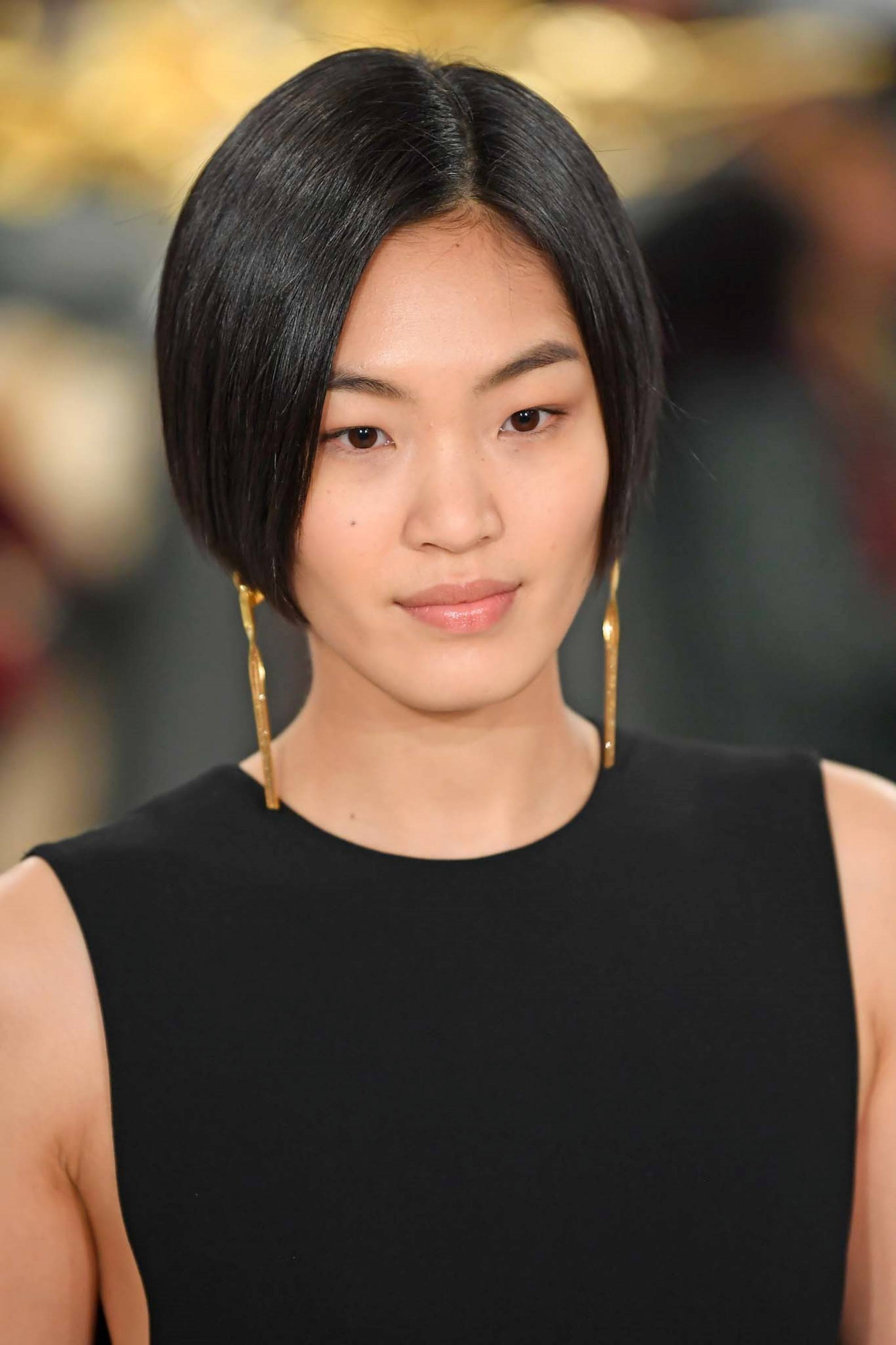 Straight bob: Closeup shot of an Asian woman with short black hair wearing a black dress