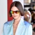 Straight bob: Closeup shot of a woman with short straight dark hair wearing sunglasses and blue suit