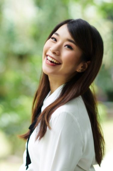 Summer-ready hair: Asian girl with long dark hair smiling outdoors