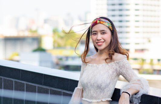 Asian woman with long hair wearing a headband