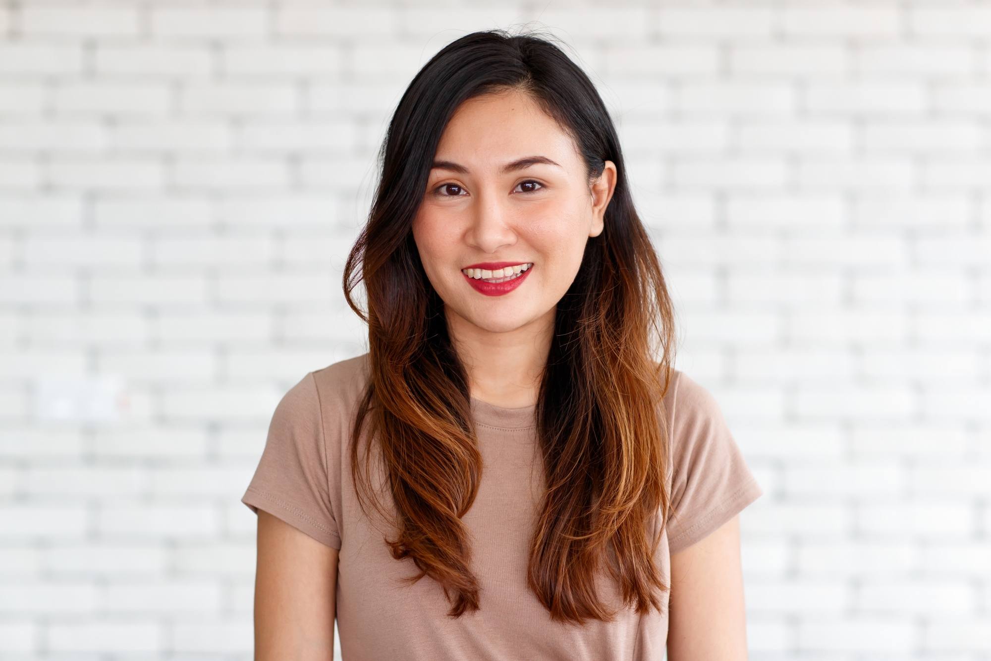 Asian woman with long caramel hair