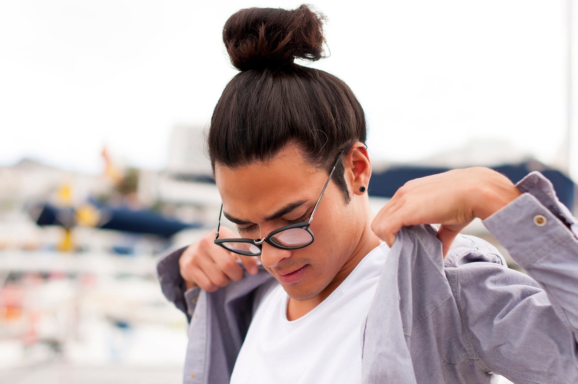 Asian man bun: Man with brown skin with long dark hair in a top knot