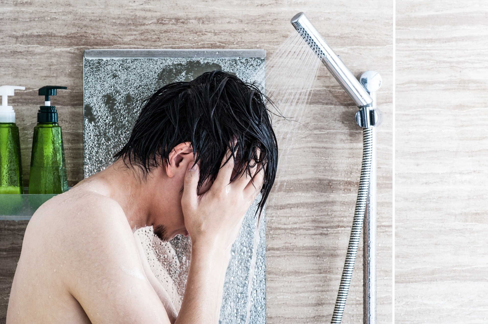 Hair care tips for men: Man covering her face in the shower