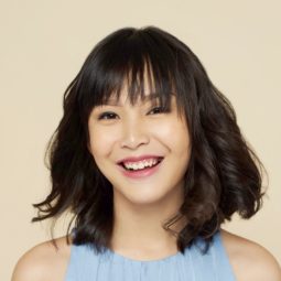 All Things Hair Summer Sale: Closeup shot of an Asian woman with wavy short hair smiling