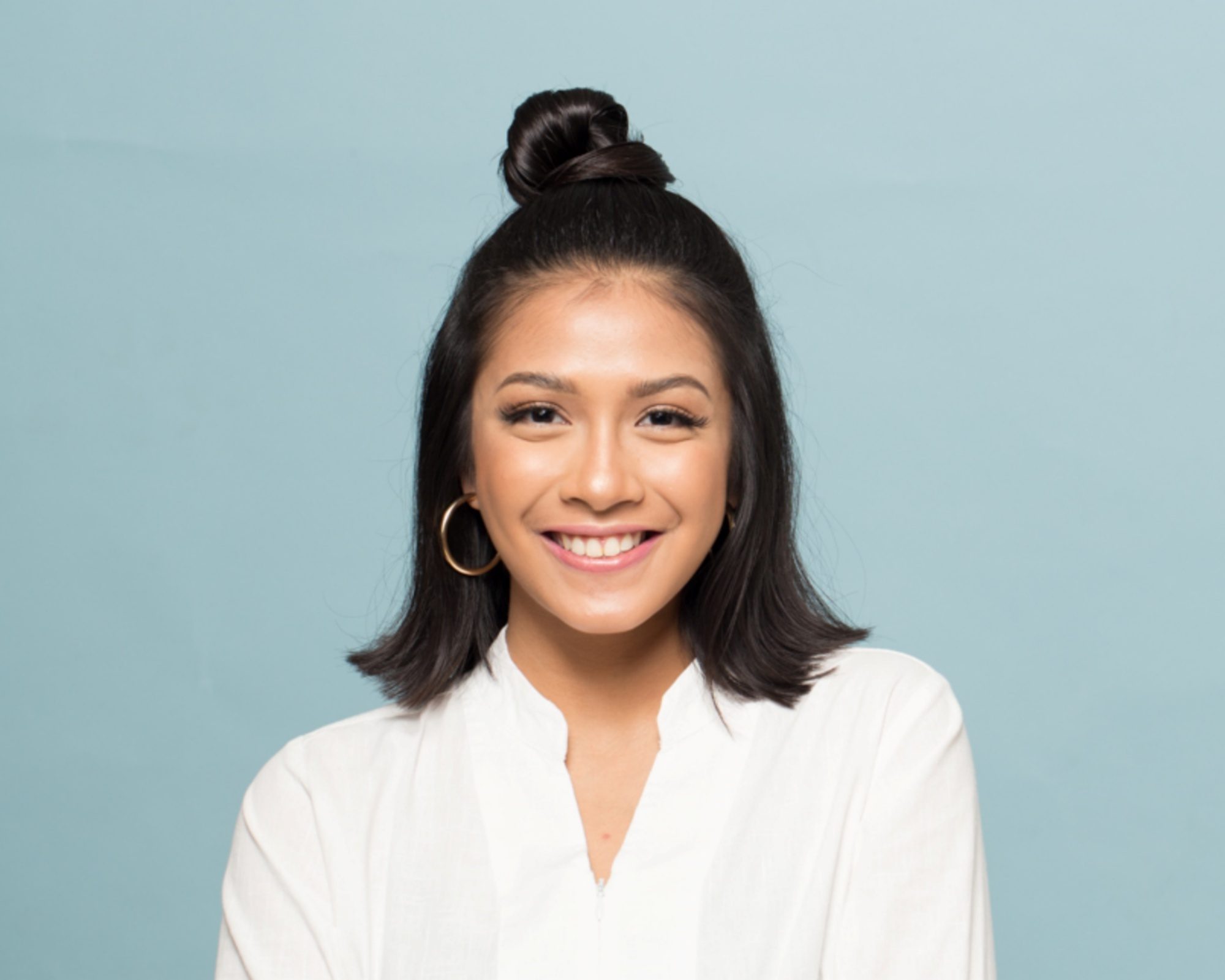 Summer updos: Closeup shot of an Asian woman with short hair and half up top knot