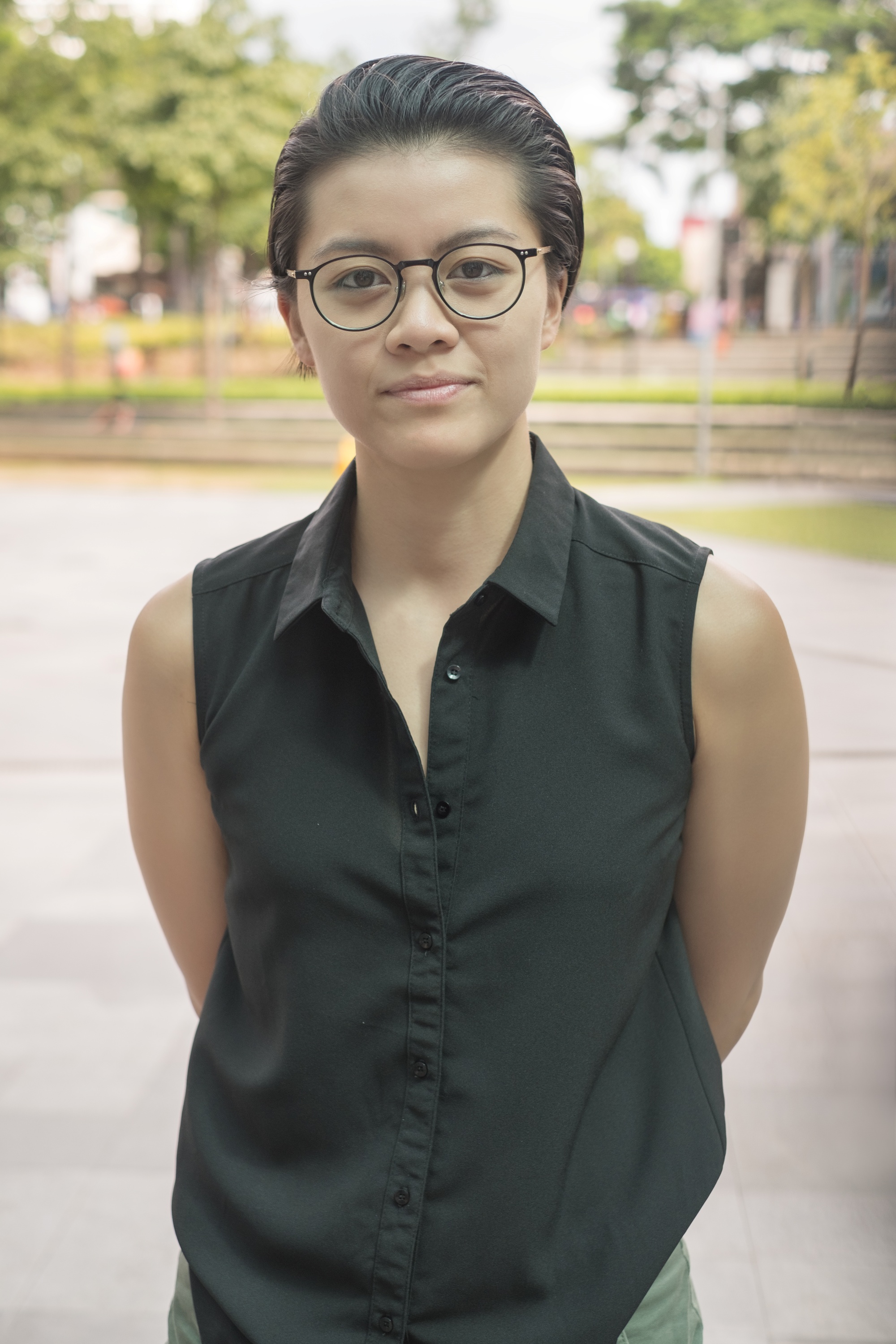 Asian woman with a slicked back pixie cut hairstyle