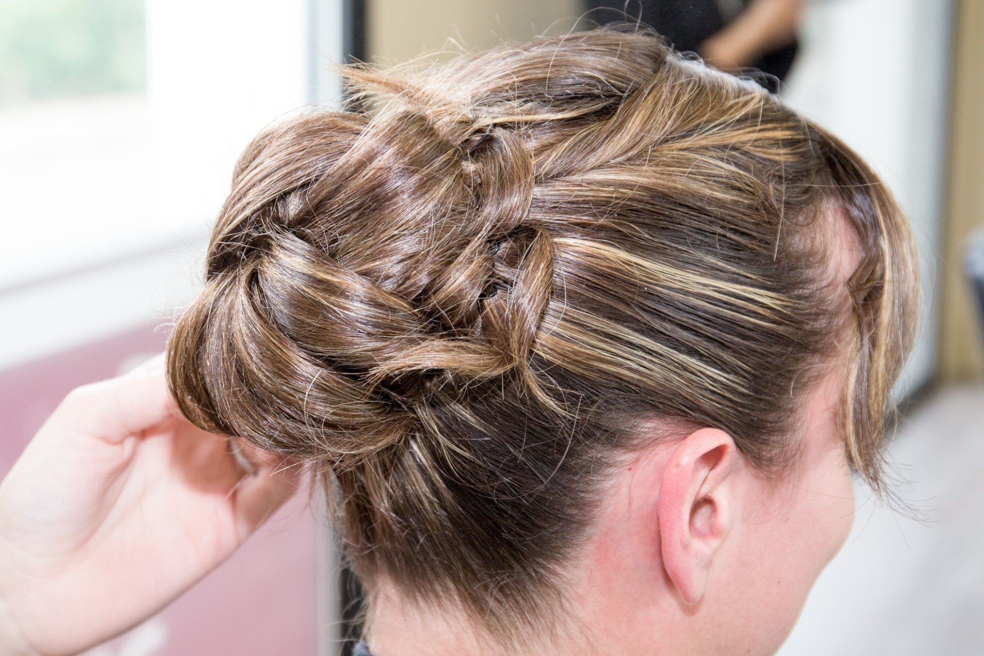 a girl's head is featured with her French twist updo