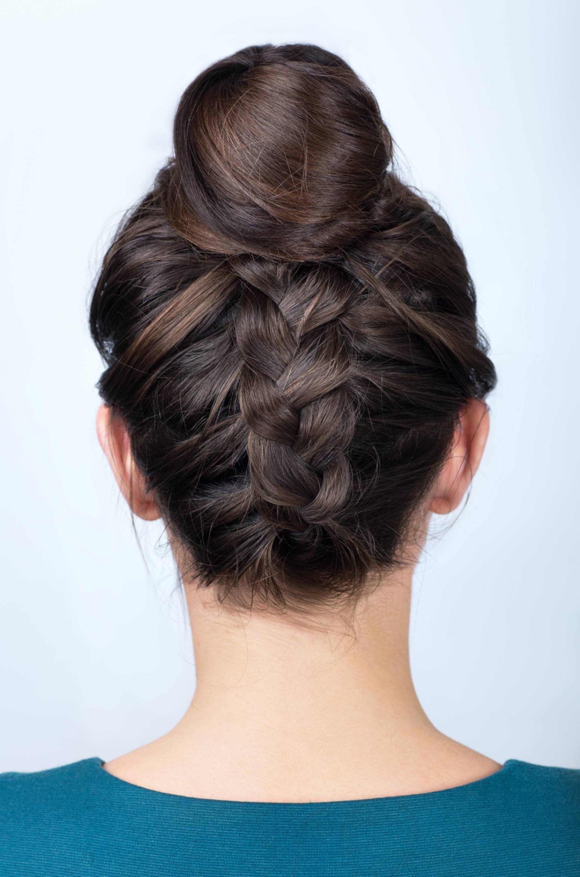 a girl with black hair wearing her hair in a nice reverse French twist updo