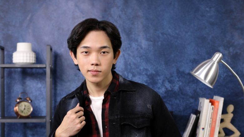 Asian man with Korean wavy hairstyle for men wearing a black leather jacket