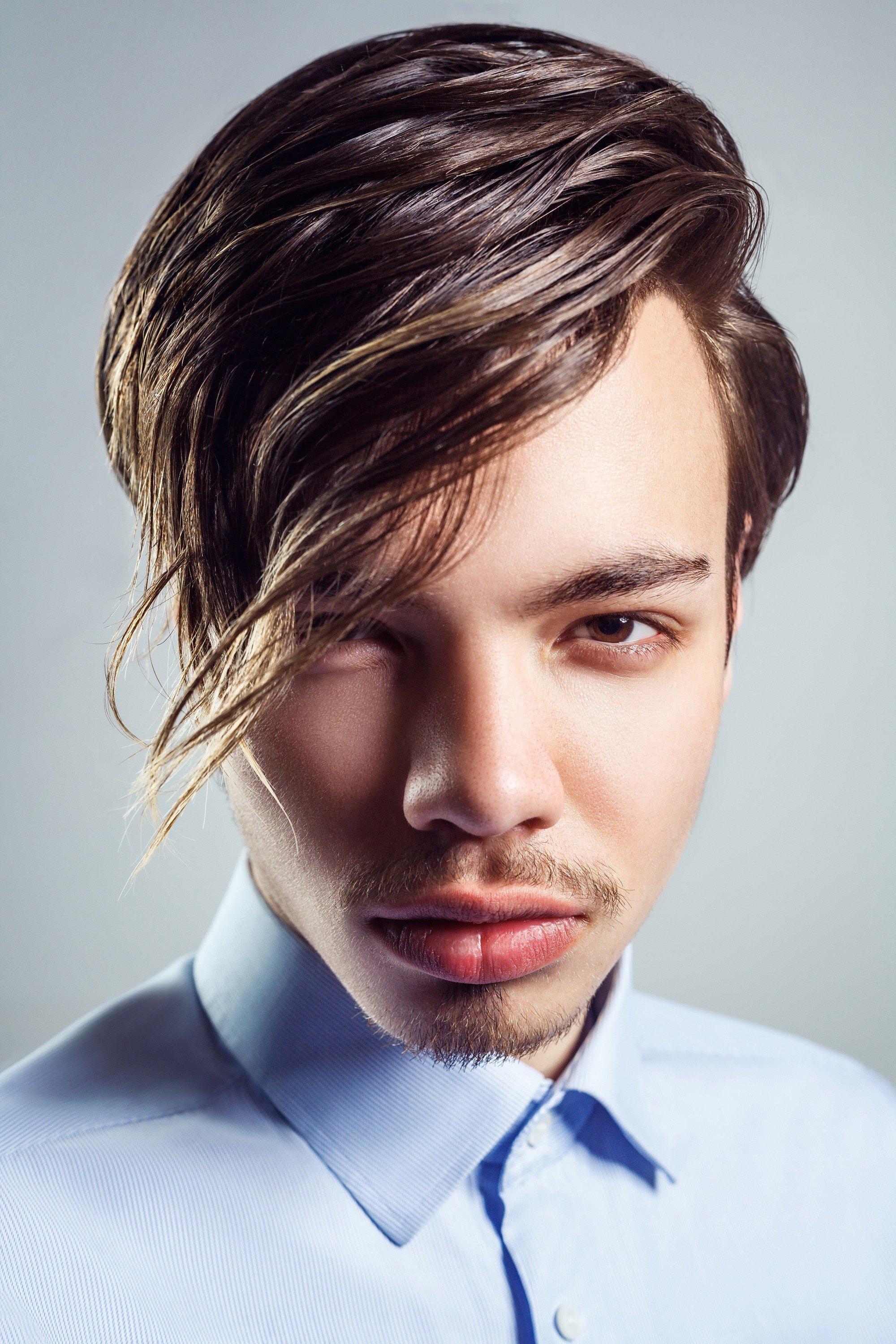 guy with Korean wavy hairstyle has long wavy bangs too