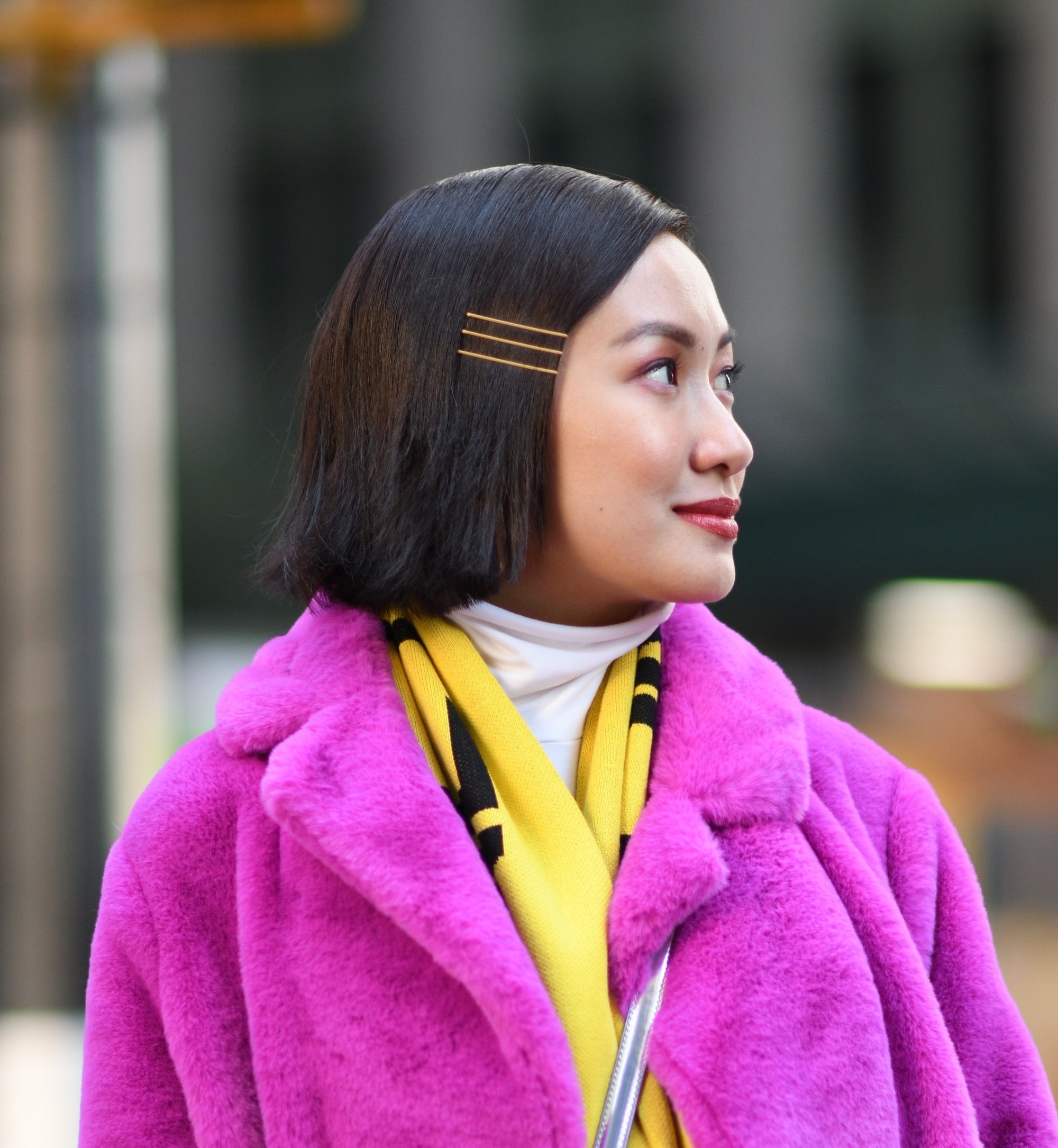 Graduation hairstyles: Closeup shot of an Asian woman with straight short hair looking sideways