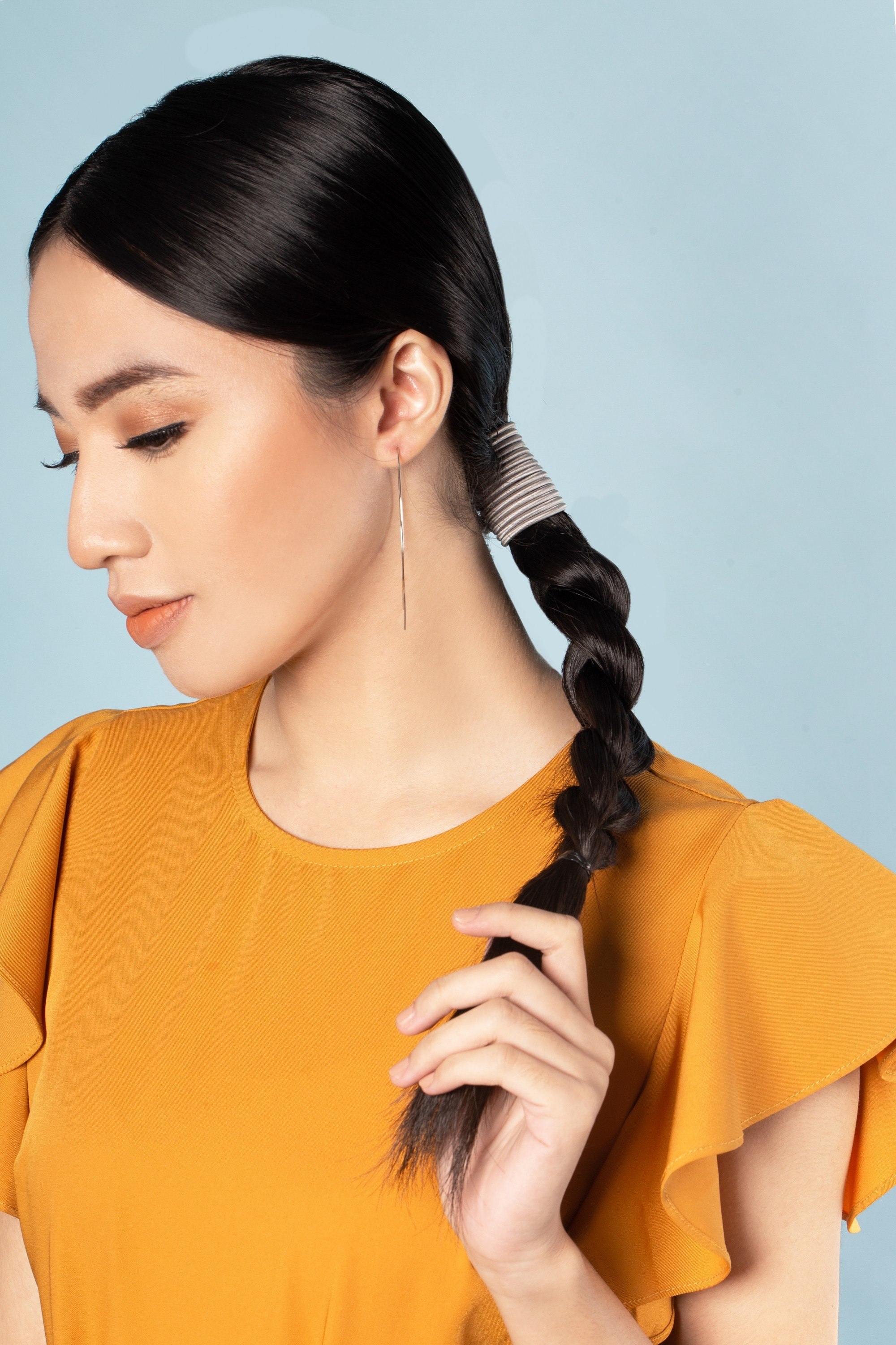 Asian woman with a braided hairstyle for graduation pictorial.