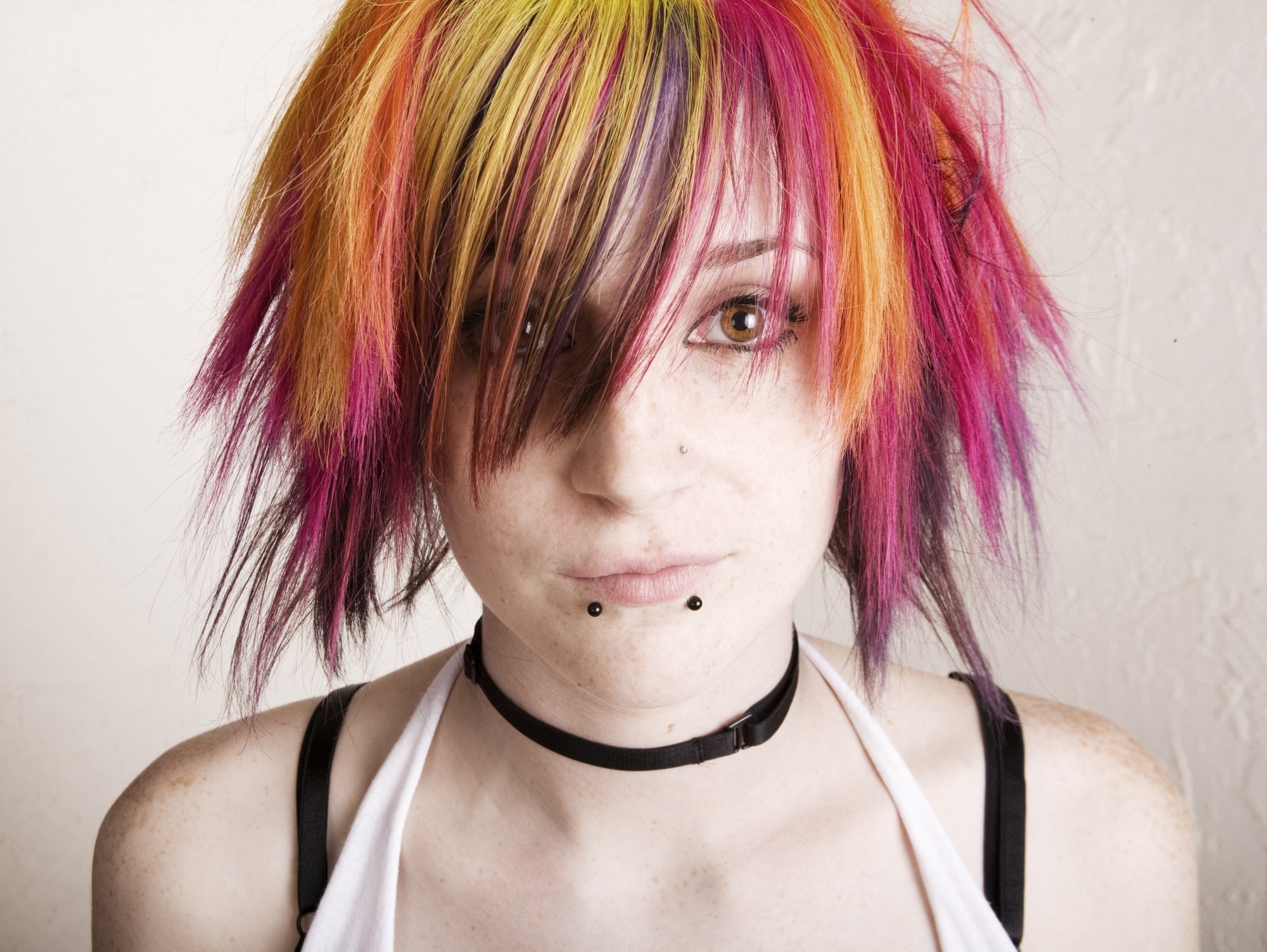 Woman with rainbow hair color on short layered hair