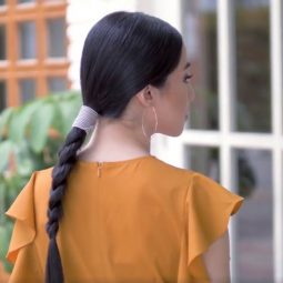 Asian woman with hair in sleek braid with accessories