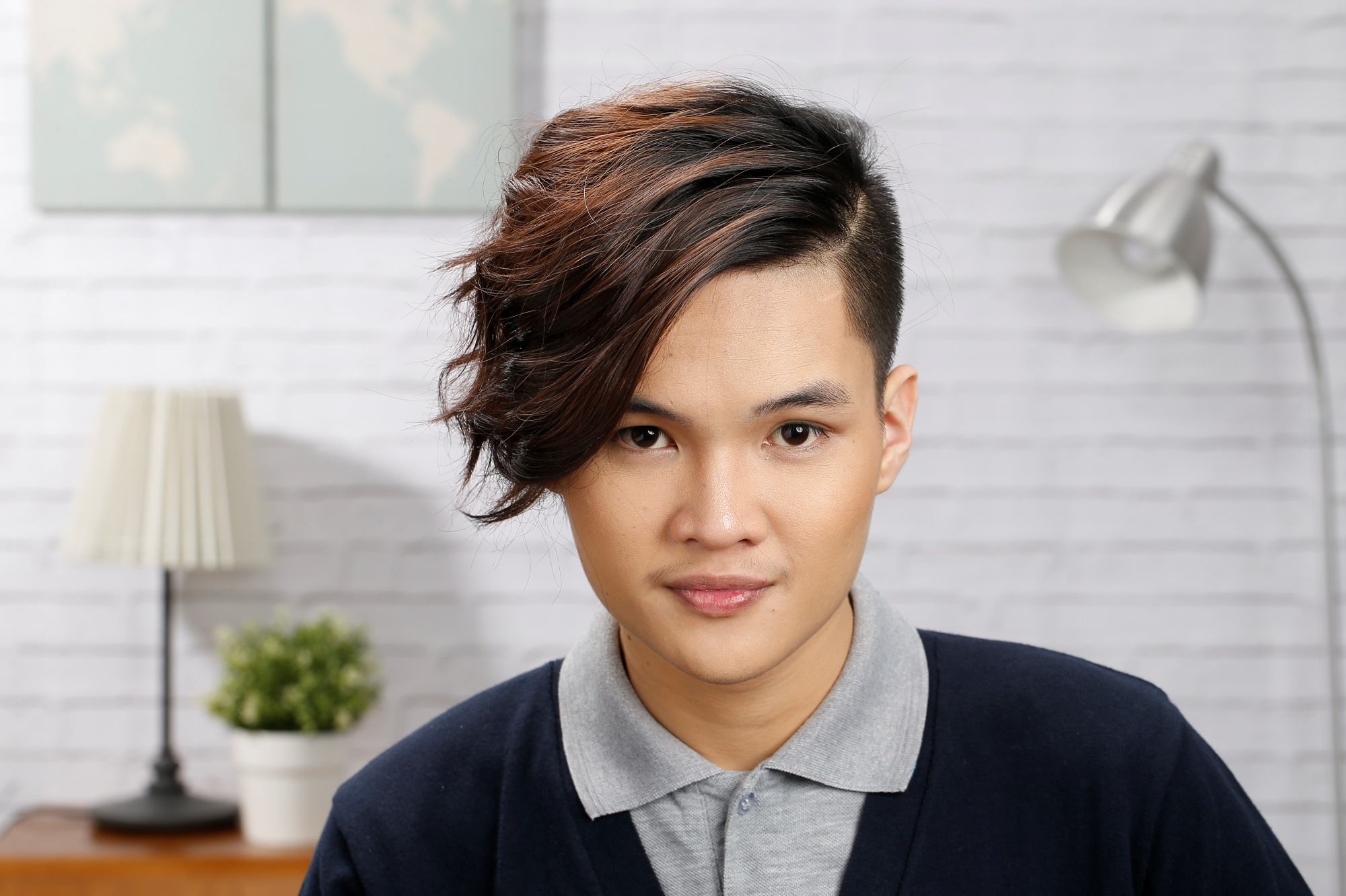 Asian man with a messy side part hairstyle