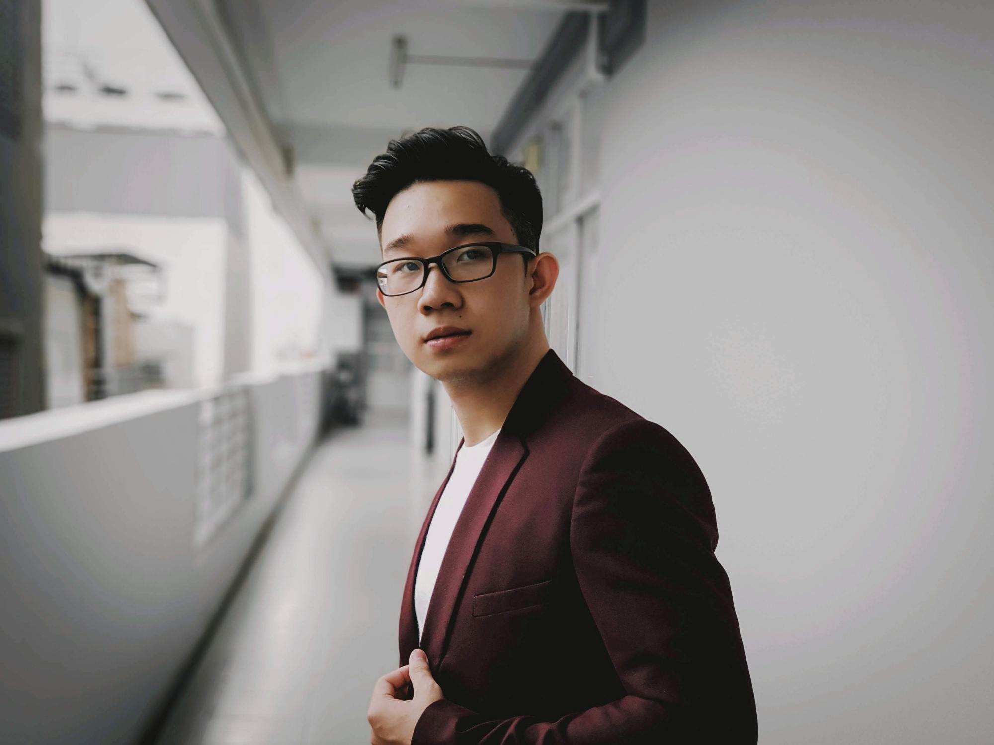 Asian man with short hair wearing eyeglasses