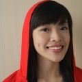 Asian woman with black hair and wispy bangs, wearing a red hoodie