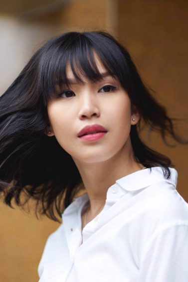 Breakup hair makeover ideas: Asian woman swinging her black hair with bangs