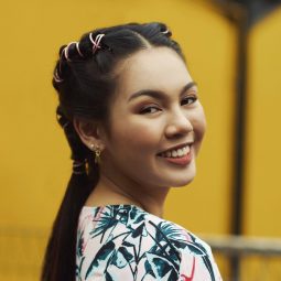 Hair design for long hair: Asian woman with pipe braids smiling