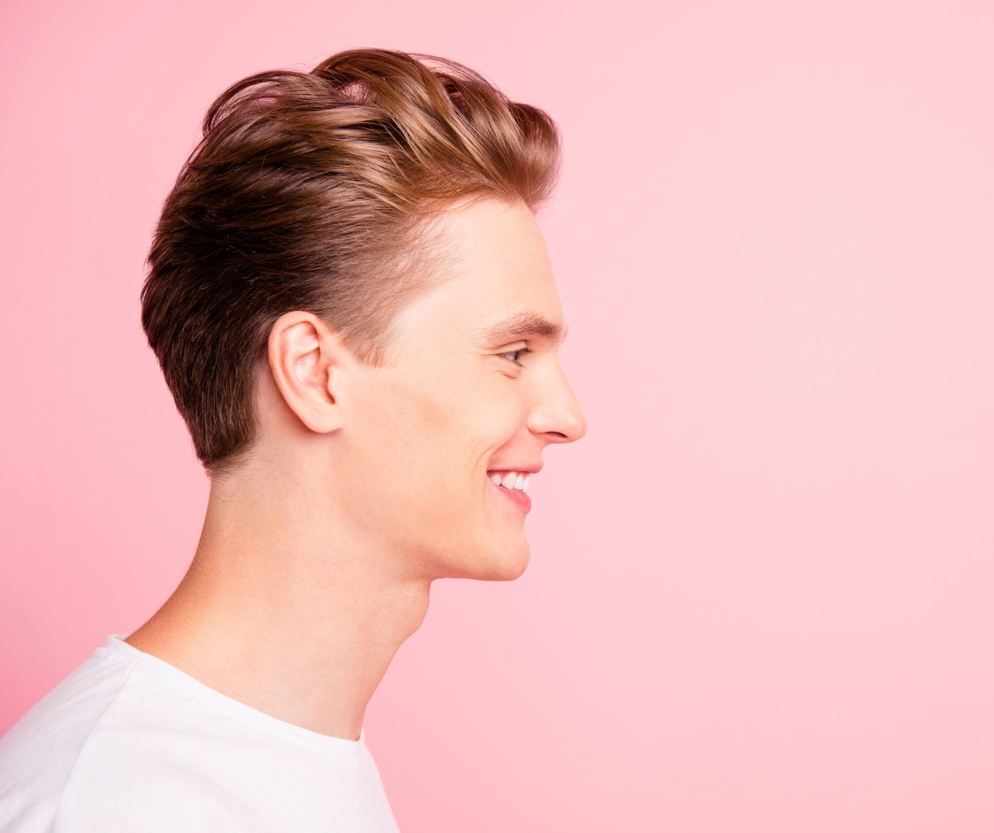 Side view shot of a man with brushed back curly hairstyle