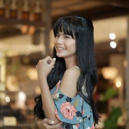 Indonesian woman with long hair in half updo with bangs