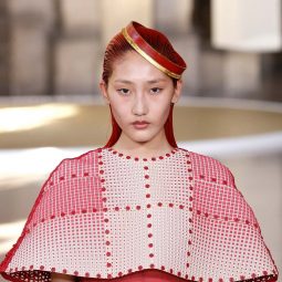 Paris fashion week haute couture model with red hair wearing a red dress
