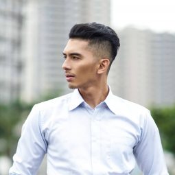 Shampoo for Men: Asian man with shaved side hairstyle wearing a white long sleeved polo outdoors
