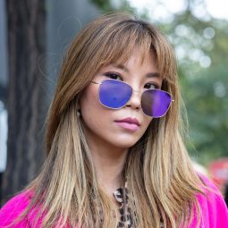 Asian woman with ash blonde hair wearing sunglasses