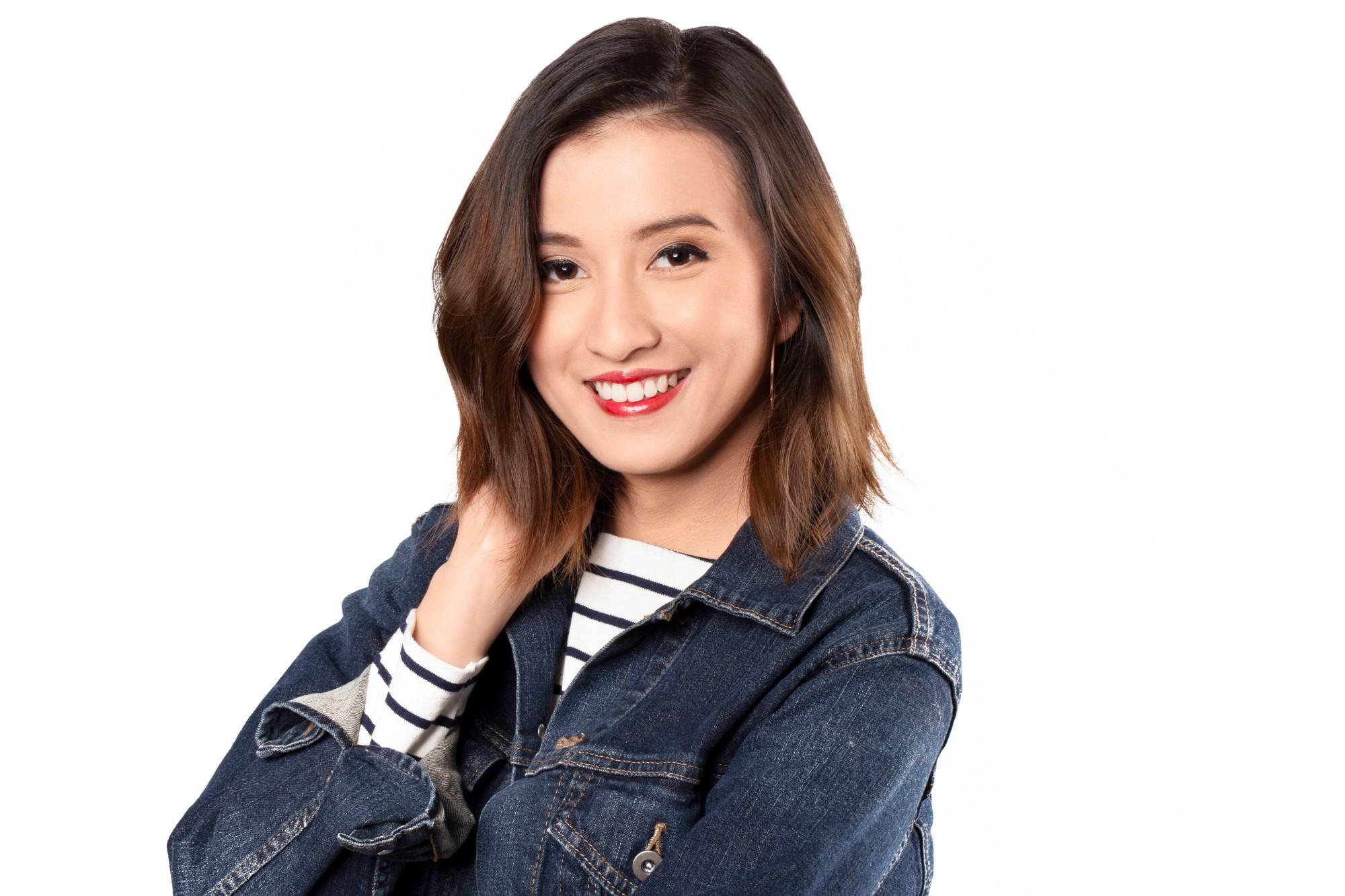 natural dandruff remedies - girl wearing a blue denim jacket is smiling