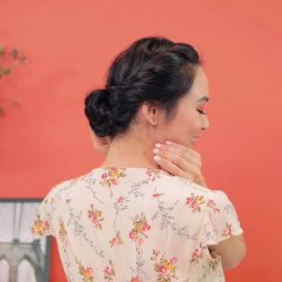 Asian woman with a French rope braid updo hairstyle wearing a floral dress