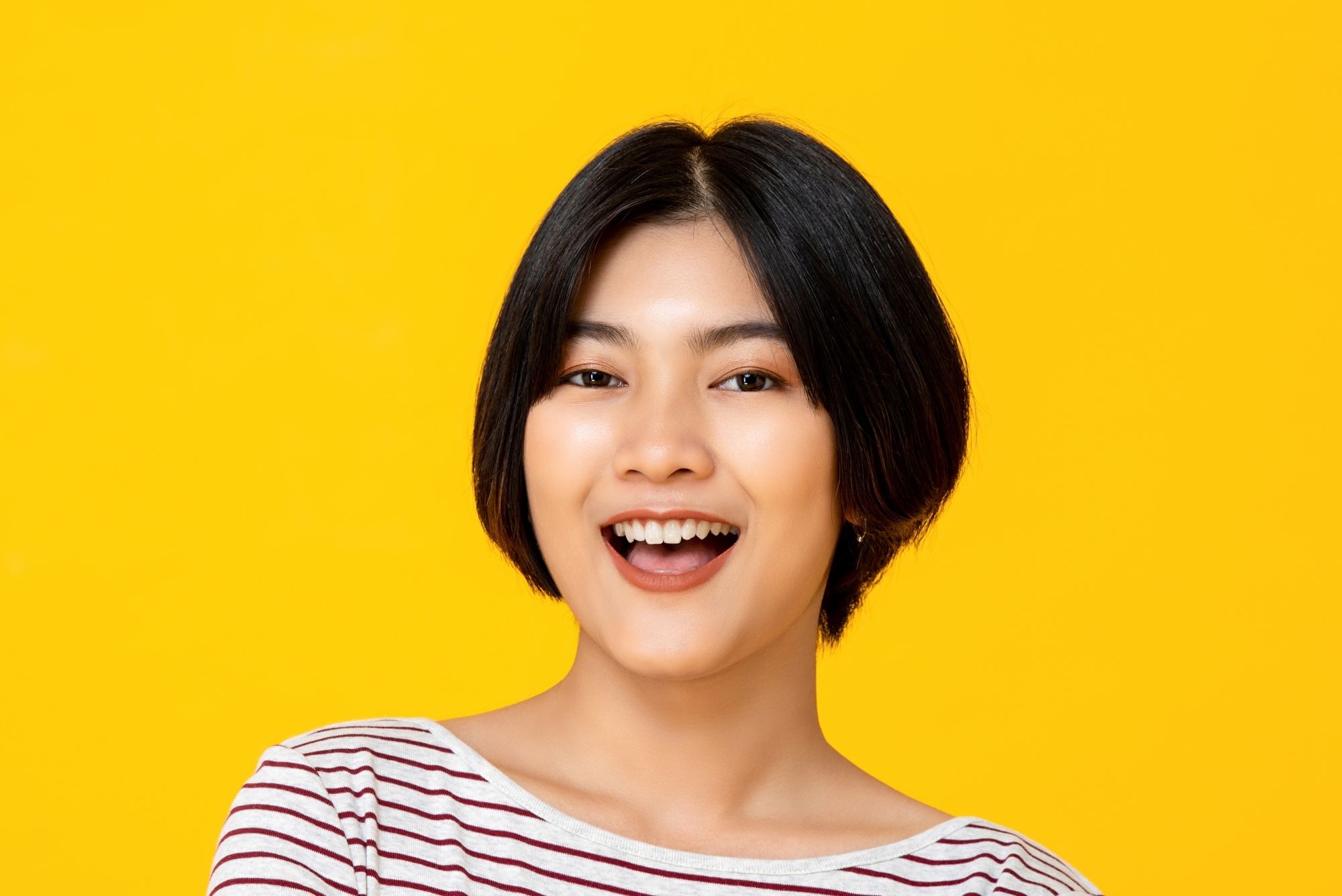 Apple cut hair: a woman smiling with her tapered apple cut