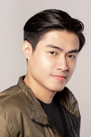 Dandruff Prevention: Asian man with dandruff-free black hair wearing a black shirt and bomber jacket