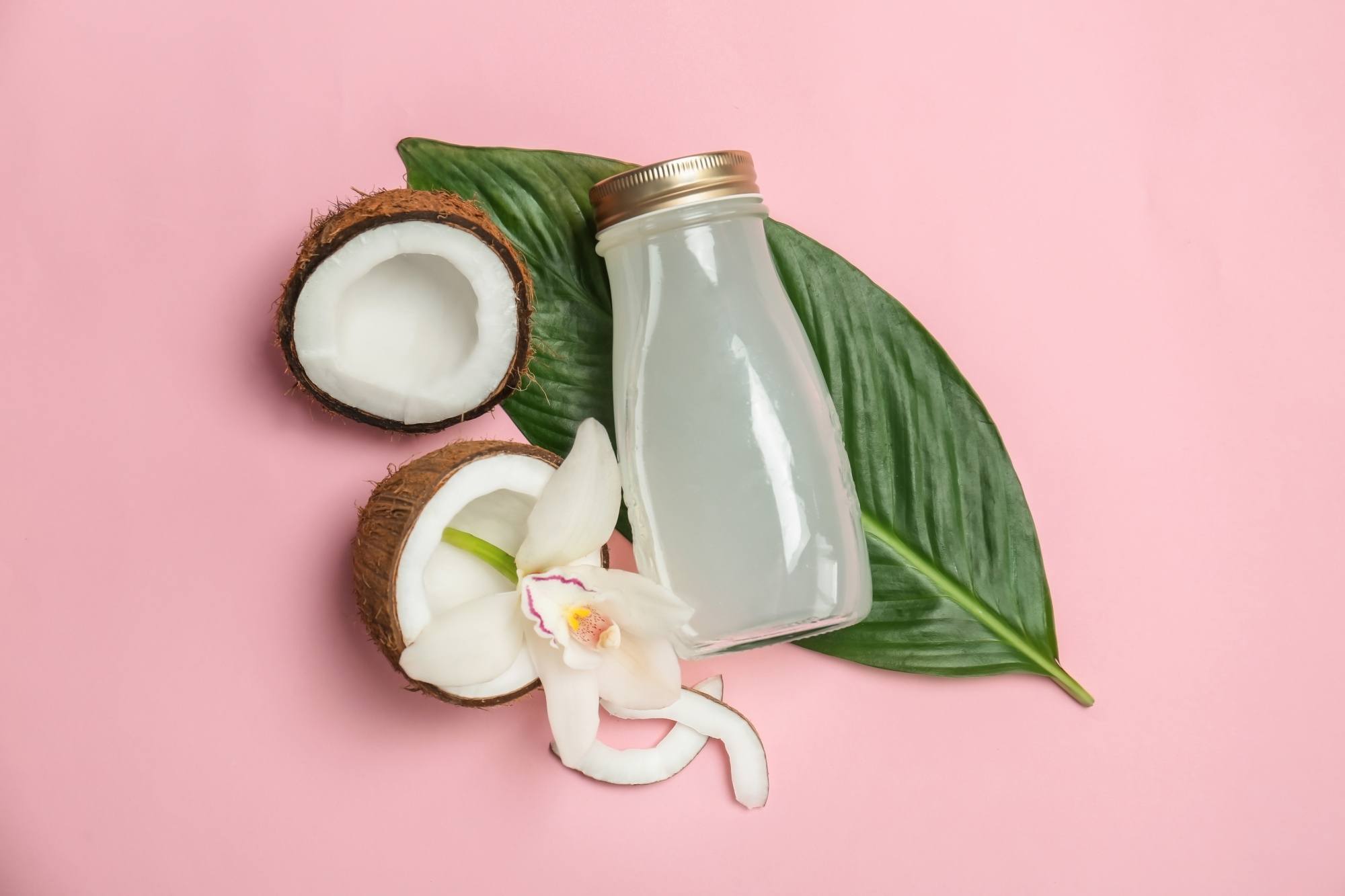 Flatlay of coconut water ad coconut halves for eco-friendly hair products story
