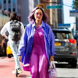 Laureen Uy street style at NYFW SS 2020 with purple hair wearing a purple dress and blue jacket