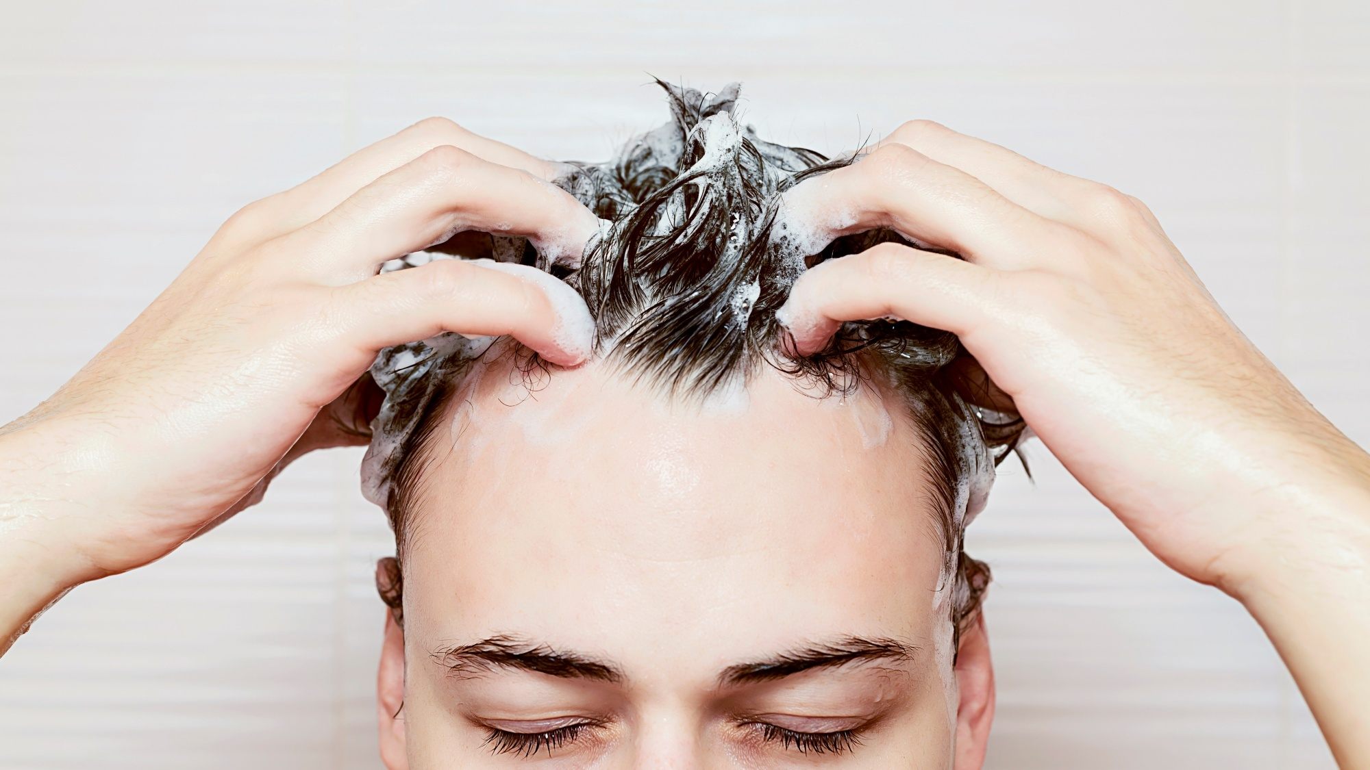 Limp hair men: a man washing his hair