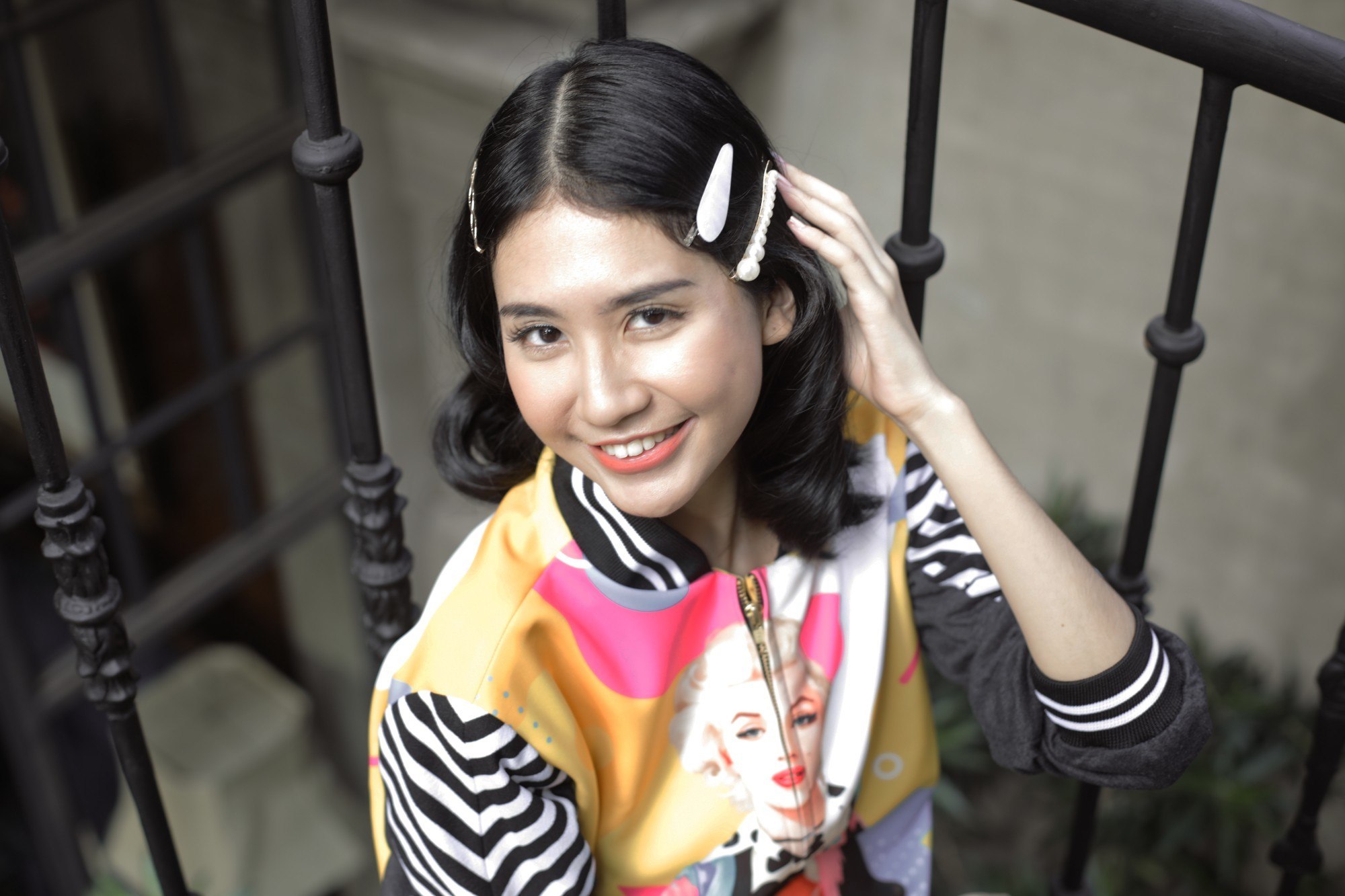 girl looking up at the camera with her pearl clips