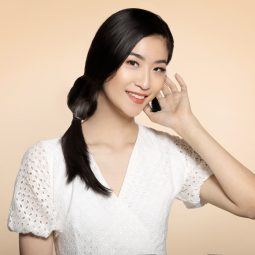 Asian woman with side knot braid hairstyle and wearing a white dress