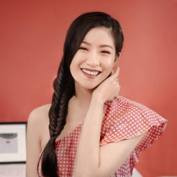 Asian woman with long braided hair smiling