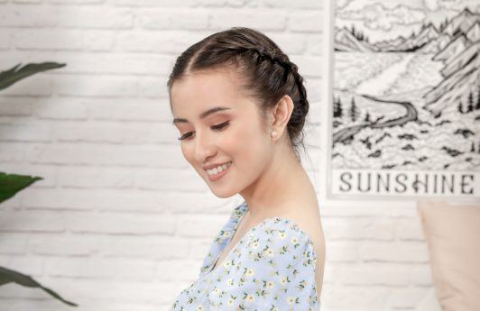 Asian woman with milkmaid braid for short hair wearing a patterned top