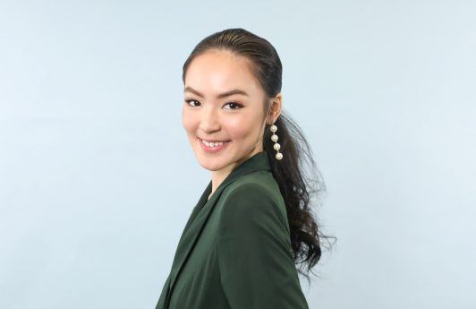 Christmas hairstyles: Asian woman wearing a green blouse with long hair